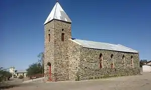 The Lentia Lutheran Church, built 1899. The village's mission church is in the background on the left.