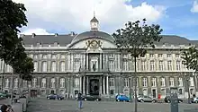 A large stone building with a clock tower on its roof