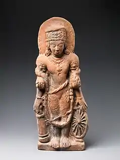 A statue of Vishnu Caturanana ("Four-Armed"), using the attributes of Vāsudeva, with the addition of an aureole around the head (5th century CE)