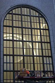 The main entrance arch as seen in 2021, during the building's renovation. There is a construction worker at the bottom of the arch.