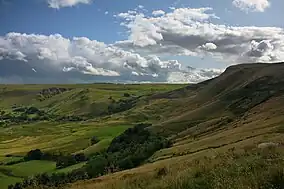 A view of grass-covered hillside located within a British National Park