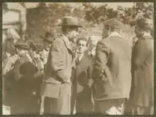 Max Weber, facing right, lecturing with Ernst Toller in the center of the background