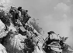 Polish soldiers carry ammunition to the front lines just before the capture of the abbey