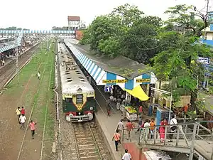 A suburban EMU train arriving at Naihati Junction