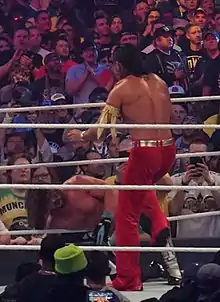 A photo of the wrestlers AJ Styles and Shinsuke Nakamura facing off at WrestleMania 34.