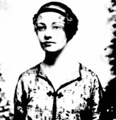 A young woman facing a camera, staring toward the right