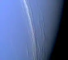 A composite black-and-white photograph showing cirrus clouds over the surface of Mars