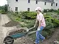 A young guest helps out in the abbey garden