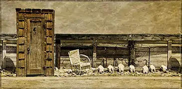 An outhouse display in an Old West setting on a Colorado ranch