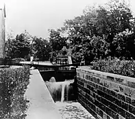 Peninsula Lock 29,Peninsula Aqueduct steel trussesover Cuyahoga River in background.