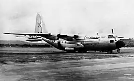 Four-engined military transport plane parked on airfield