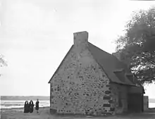 Two nuns of the Congregation of Notre Dame and a secular stand near the Saint-Dizier house