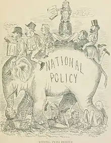 A group of men sitting on an elephant. The elephant has the phrase "National Policy" on their side