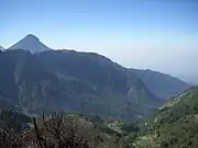 Looking from the ridgeline down into the old volcanic edifice, with the peak of Volcan Santa Maria in the background.