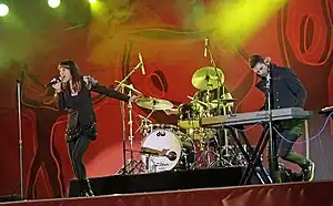 Rogue Traders performing live at FIFA Fan Fest, Sydney, June 2010.Mindi Jackson at left, James Ash at right, Peter Marin obscured behind drum kit.