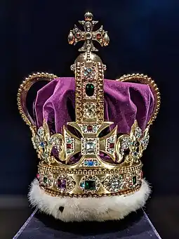 Large gold crown decorated with diamonds and red, green, blue, and purple gemstones