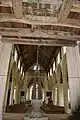 View showing the belfry timbers, the font cover and general view east