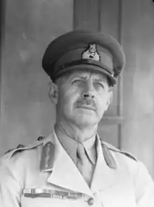 Painting – Formal portrait of a First World War general in khaki uniform, with red hat band and collar tabs, gold braid and Sam Browne belt.