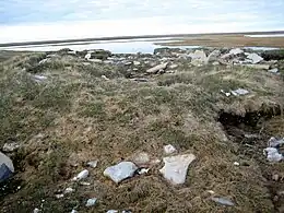 Remnants of older Inuit sod houses in Igloolik Point