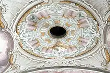 Holy Spirit hole hung with a wooden dove, Saints Peter and Paul parish church in Söll.