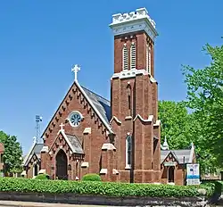 Brick church with tall three-story belltower