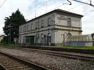 Two-story building with gabled roof next to railway tracks