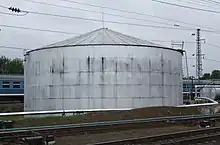 An old cylindrical oil storage tank.