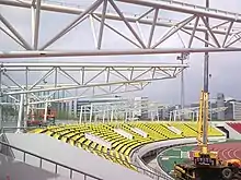 The white, robust frames of canopy are standing above the ground of Tancheon stadium. It was 2009 when the Tancheon Stadium was under refurbishment for canopy installation.