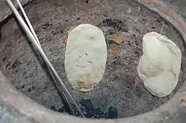 Roti cooking in a tandoor