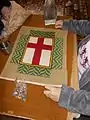 Florentine tapestry work around a St George's Cross kneeler