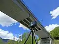 Retroreflector prism on top of a bridge deck