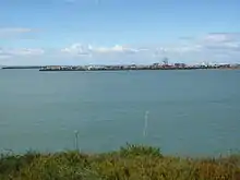 Photograph showing large breakwater constructed at the mouth of Timaru Port.