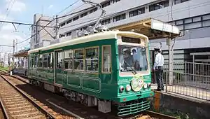 Tramcar number 7701 in green livery