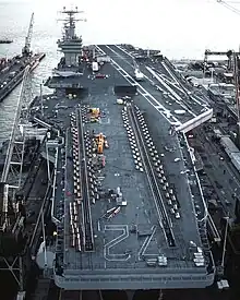 Abraham Lincoln in drydock. Equipment and vehicles are on deck for the overhaul