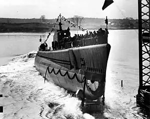 The crew of the Kingfish (SS-234) line the rails as she slides down the launching ways at Portsmouth Navy Yard.