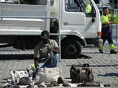 Street vendor with a string and sheet set-up allowing for quick departure.