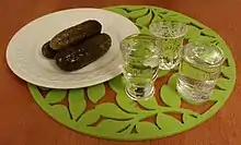 Image 23Clear vodka served with pickled cucumber – the usual way of consuming it in Slavic countries of the so-called "vodka belt". (from List of national drinks)