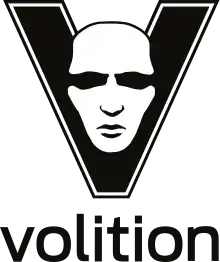 The letter "V" is displayed in black, with a white, male face shown in its center. Below the letter, the word "Volition" is rendered in lower-case letters.