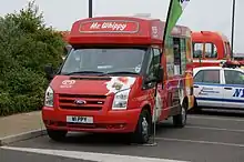  Red van decorated with pictures of different types of ice lolly which says "Mr Whippy" on the front of the roof