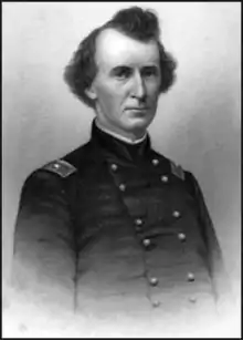 Black and white print of a man in a dark military uniform with two rows of buttons. He has bushy tufts of dark hair over each ear and on top of his head.