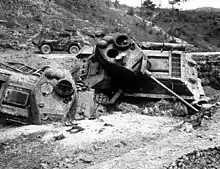 A pair of heavily damaged tanks destroyed in a ditch