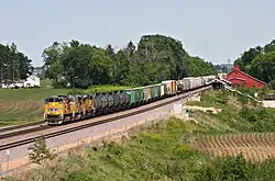 A Union Pacific Railroad freight train rolls past the La Fox depot and the Potter & Barker grain elevator on June 12, 2011.