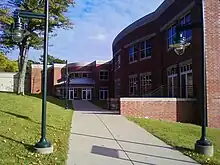 Picture of a campus building with a walkway on an autumn day